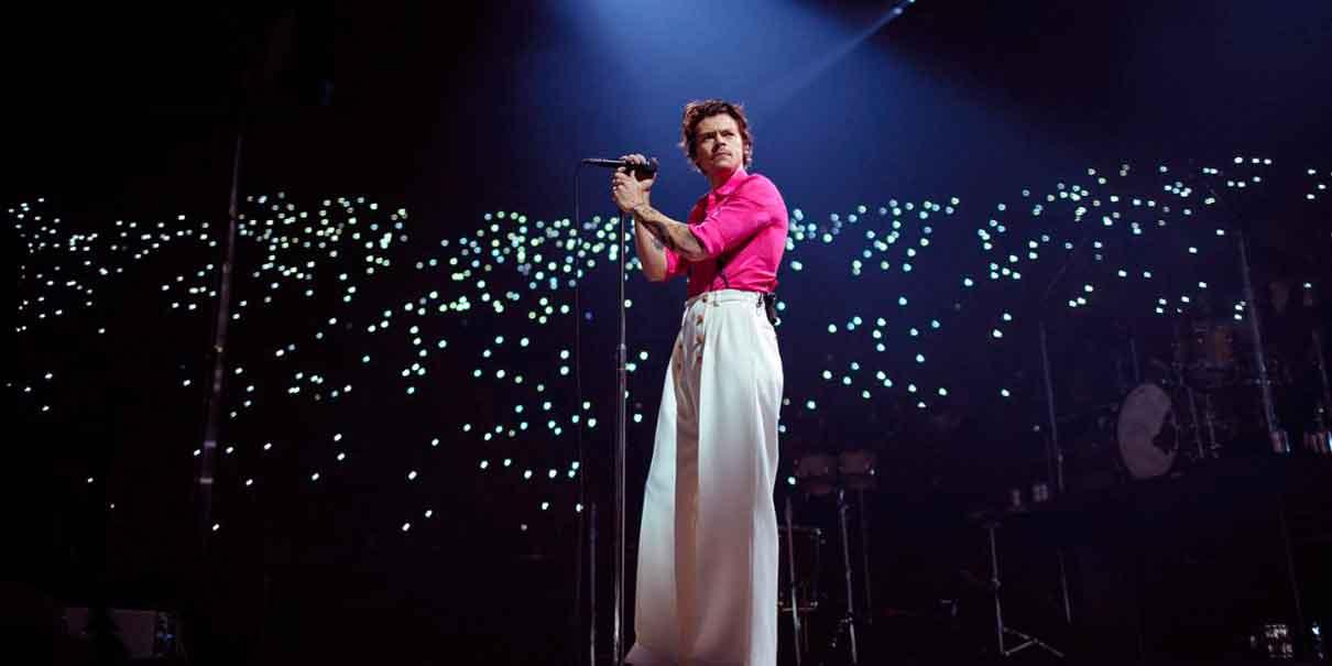 Harry Styles performing on stage for fans